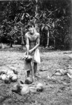 105-Malay-boy-husking-coconuts.jpg