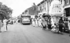 147-Priest-in-robes-and-umbrella-and-funeral-band.jpg